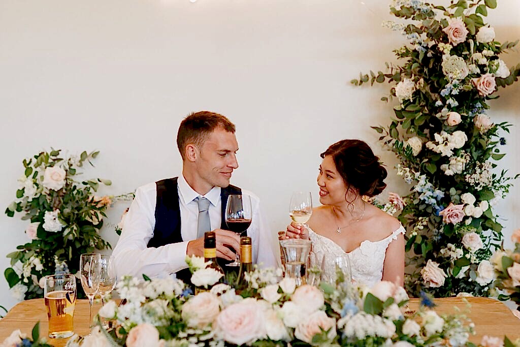 Bride and Groom celebrating at the top table after their marriae