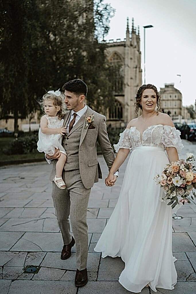 Bride and groom walking through central Bath after tying the knot