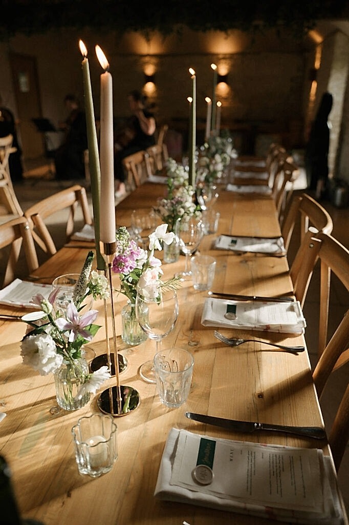 Table florals and candles set up for a wedding