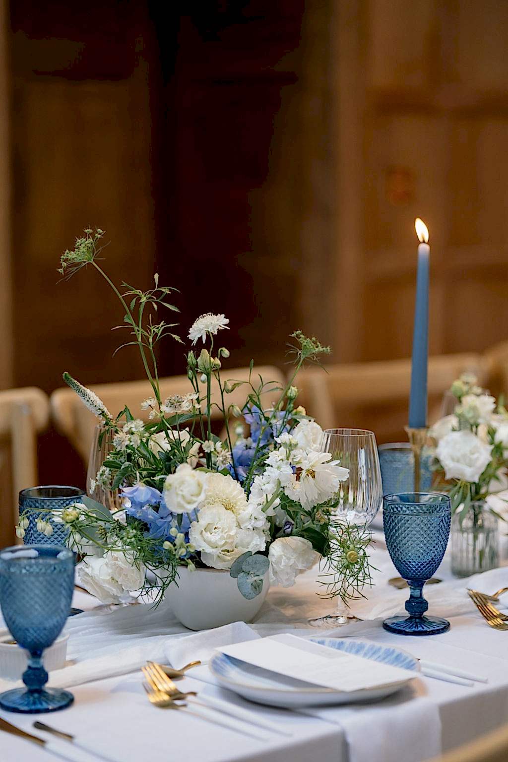 Compote bowl of flowers on reception table at wedding